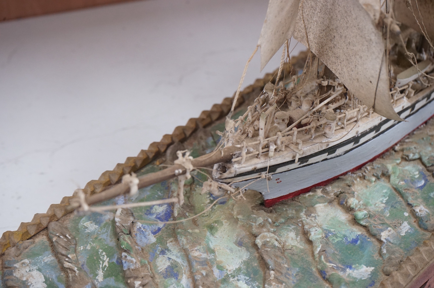 A bone and painted wood model of a three masted ship, 55.5cm wide. Condition - fair to good